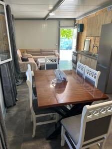 a kitchen and dining room with a wooden table and chairs at David's House in Ndërlysaj