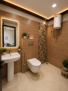 a bathroom with a toilet and a sink at Urben BellaMount Hotel - Free Airport and Aerocity Pick Up & Drop in New Delhi +23 photos
