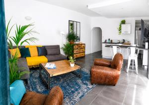 a living room with a couch and a table at Beautifully Bright Apartment in Old Town Saint-Tropez in Saint-Tropez