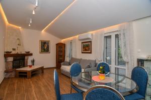 a living room with a glass table and chairs at Guest house Šebelj in Budva