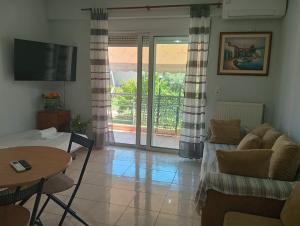 a living room with a couch and a table at Central 26 apartment in Kalamata in Kalamata