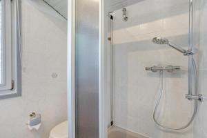 a bathroom with a shower and a toilet at Ferienhaus Hennesee in Meschede +23 photos