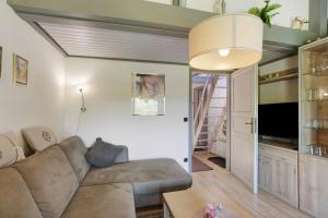 a living room with a couch and a tv at Ferienhaus Hennesee in Meschede