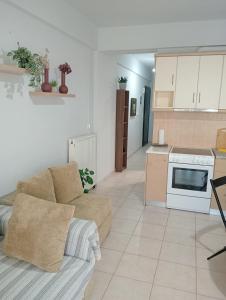 a living room with a couch and a kitchen at Central 26 apartment in Kalamata in Kalamata
