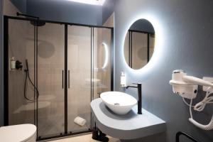 a bathroom with a shower and a toilet and a sink at I Segreti del Chiostro - Le Dimore in Palermo +3 photos