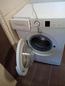 a washing machine with its door open in a room at Central 26 apartment in Kalamata in Kalamata +4 photos