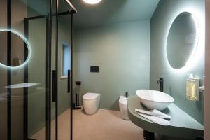 a bathroom with a sink and a toilet and a mirror at I Segreti del Chiostro - Le Dimore in Palermo