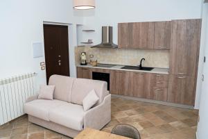 a living room with a couch and a kitchen at Borgo Izzo 2 in San Fele