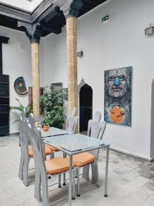a dining room with a glass table and chairs at Riad7 in Azemmour