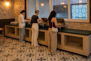 a group of people standing at a counter at High Five Hotels Phase 2 in Assagao