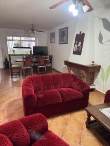 a living room with a red couch and a table at La Mary duplex in Federación