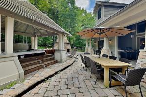 a patio with a wooden table and an outdoor grill at Stone Mountain Vista in McHenry