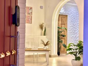 a hallway with a table in front of a door at Vintage River Homestay in Varanasi +48 photos