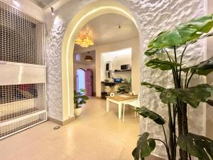 a hallway with plants and an archway in a house at Vintage River Homestay in Varanasi