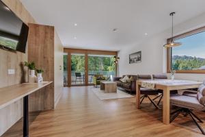 a living room with a table and a couch at Apartment Waldesruh in Oetz