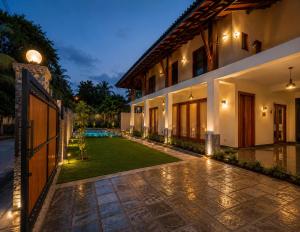 a courtyard of a house with a lawn at Novara Haven Airport Transit Hotel in Katunayaka