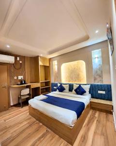 a bedroom with a large bed in a room at THE MASARA MANAR Hotel in Gwalior