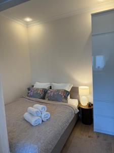 a bedroom with a bed with towels on it at Sunny Central Apartment on Central Square in Daugavpils