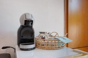 a coffee maker and a basket on a counter at Dionysus House in Magoulás