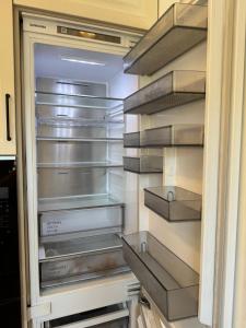 an empty refrigerator with its door open at Sunny Central Apartment on Central Square in Daugavpils +7 photos
