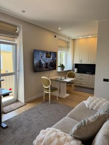 a living room with a couch and a table at Sunny Central Apartment on Central Square in Daugavpils