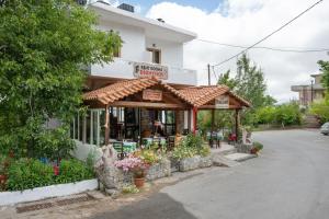 a flower shop with a sign on a building at Dionysus House in Magoulás