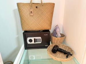 a microwave and a toaster on a glass table with a basket at Areeya Khao Khad Aoyon Beach in Ban Ao Makham