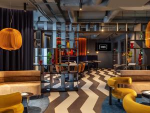 a lobby with couches and tables and chairs at TRIBE Krakow Old Town in Krakow