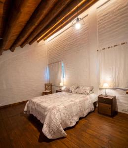 a bedroom with a bed and two night stands and two lamps at BanTelmo in Juana Koslay  +14 photos