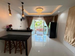 a kitchen with a black counter and a refrigerator at Areeya Khao Khad Aoyon Beach in Ban Ao Makham