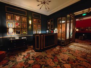 a living room with a table and a wall of pictures at Alba Opéra Hôtel in Paris