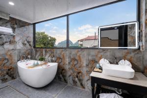a large bathroom with a large tub and a sink at Tam Coc Center Friendly Hotel in Ninh Binh