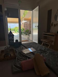 a bedroom with a bed with a view of the ocean at Seaview Apartments in Anavyssos