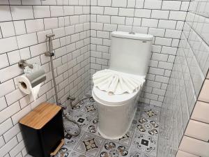 a bathroom with a toilet in a white tiled room at Areeya Khao Khad Aoyon Beach in Ban Ao Makham +22 photos