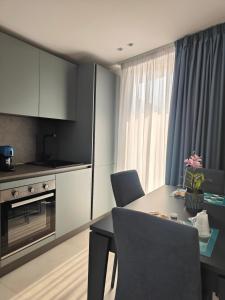 a kitchen and dining room with a table and chairs at AnnAmuri in Belpasso