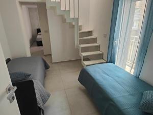 a small bedroom with a bed and a staircase at AnnAmuri in Belpasso