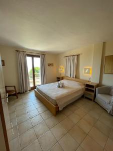 a bedroom with a large bed and a couch at Villa Kim in Achladies
