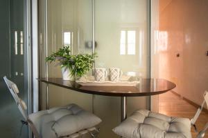 a round table with two chairs in a room at Youhosty - Duomo Studio Apartment in Milan
