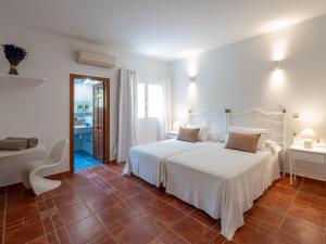 a bedroom with two beds and a bathroom at Ses Casetes Abajo in San Jose +56 photos