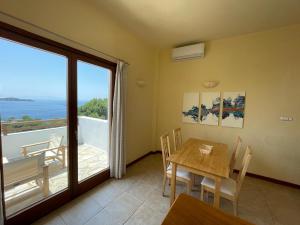 a dining room with a table and a view of the ocean at Villa Kim in Achladies