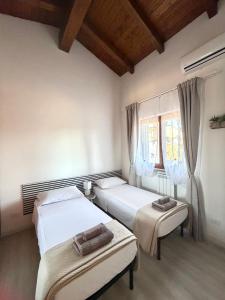 a bedroom with two beds and a window at VILLA SEASIDE HAVEN - Private Retreat with Garden in Anzio in Anzio +43 photos