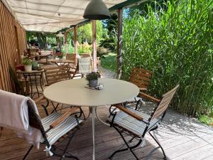 a patio with a table and chairs on a deck at Landhaus Maltzien - Auszeit auf dem Land in Maltzien