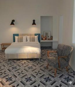 a bedroom with a bed and a chair at Le Dimax in Sant'Agnello