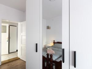 a bedroom with white doors with a bed in it at Apartman Mila Raška in Raška +4 photos