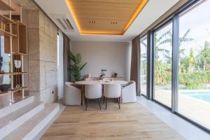 a dining room with a table and chairs and large windows at Leaf Villa Terra in Antalya +29 photos