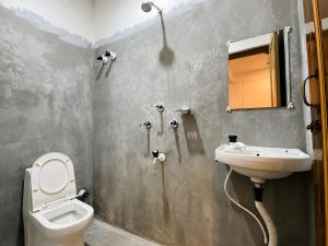 a bathroom with a toilet and a sink at Goshen dormitory in Siliguri