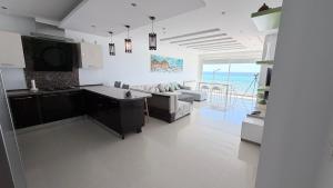 a kitchen and living room with a view of the ocean at Le paradis 210 in Kelibia