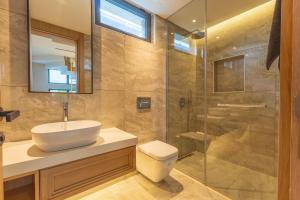 a bathroom with a toilet and a sink and a shower at Leaf Villa Terra in Antalya
