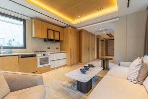 a living room with a couch and a table at Leaf Villa Terra in Antalya