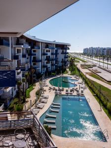 a view of a swimming pool with chairs and a building at Zephyr Martil in Martil